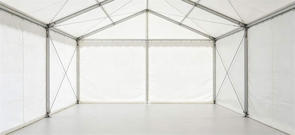 Interior view of frame relief tent showing straight walls and roof support