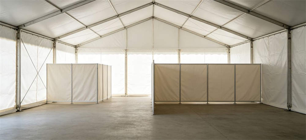 Interior of relief tent showing fabric partition wall creating zones