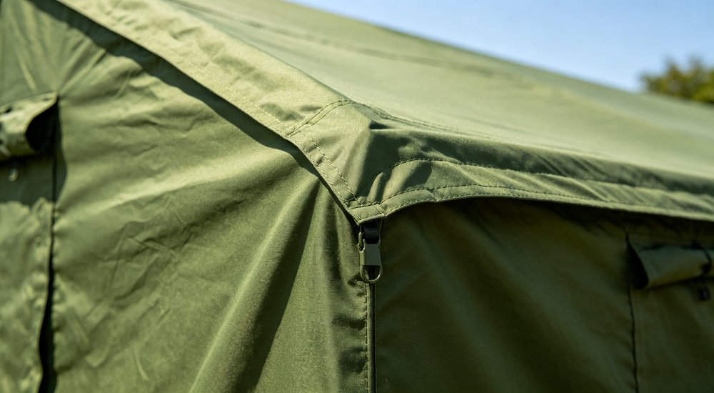 Heavy duty emergency frame tent displayed in operational setting demonstrating quick setup capability durable canvas exterior and spacious interior capacity for humanitarian relief missions