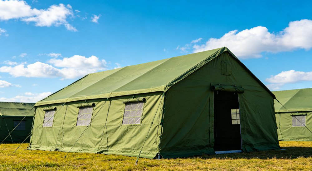 Emergency response tent captured during active deployment showing professional grade construction wind resistant frame and waterproof covering designed for long term use in challenging field conditions