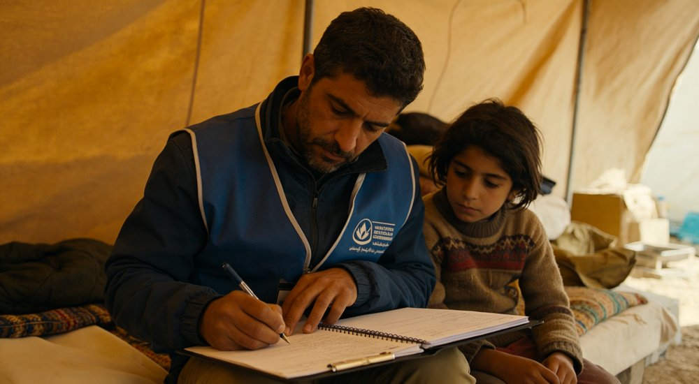 Field deployed emergency shelter showing robust frame construction waterproof material and practical design features meeting international standards for disaster response and refugee accommodation
