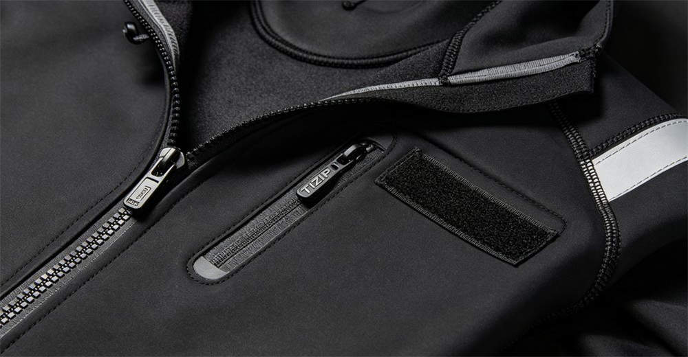 Close-up detail of professional dry suit showing waterproof zipper, sealed seams, and adjustable wrist and neck seals for water rescue