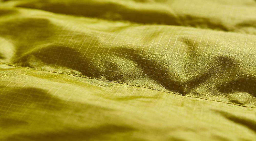 Close up of ripstop sleeping bag fabric texture, anti-tear grid pattern material, durable outer shell detail, macro photography Close up of ripstop sleeping bag fabric texture, anti-tear grid pattern material, durable outer shell detail, macro photography